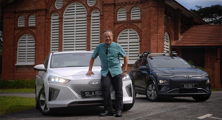 Speed King Leslie Chang sitting on the Grille of his Electric Vehicle